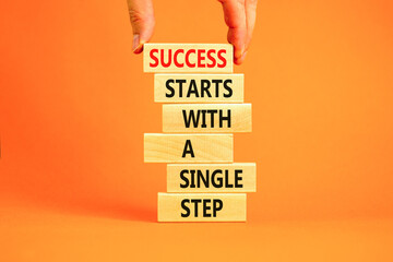 Success symbol. Concept words Success starts with a single step on wooden block. Beautiful orange table orange background. Businessman hand. Business success starts with single step concept Copy space