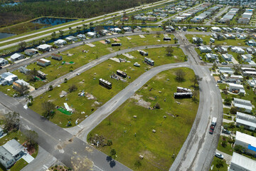 Destroyed RV camper vans and and mobile homes after hurricane in Florida residential area. Consequences of natural disaster