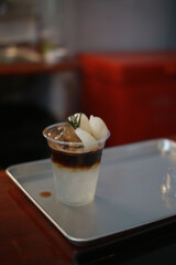 Closeup of Iced Caramel Macchiato at the coffee shop, Caramel Macchiato is a classic macchiato beverage. It consists of vanilla syrup, espresso, steamed milk, foam, and caramel drizzle
