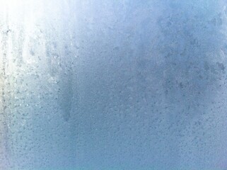 Frost on the window pane. Frosty pattern.