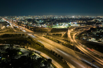View from above of american big freeway intersection in Miami, Florida at night with fast moving...