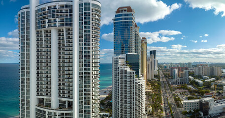 Fototapeta na wymiar View from above of luxurious highrise hotels and condos on Atlantic ocean shore in Sunny Isles Beach city. American tourism infrastructure in southern Florida