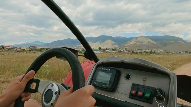 View of steering wheel from seat extreme off road tour on quad buggy vehicles
Quad buggy vehicles race, extreme sports transport, driving off-road.  4wd buggy atv utv adventure.
Buggy extreme ride 