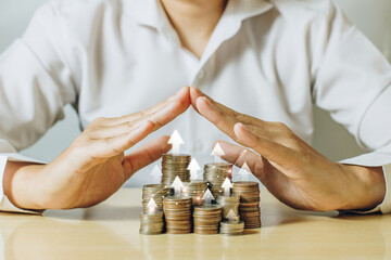 A man hands covering coins stacks with white up arrow. Money coins for financial, business growth...