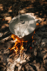 Cooking in a pot over campfire