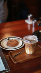 Closeup of Iced Caramel Macchiato at the coffee shop, Caramel Macchiato is a classic macchiato beverage. It consists of vanilla syrup, espresso, steamed milk, foam, and caramel drizzle