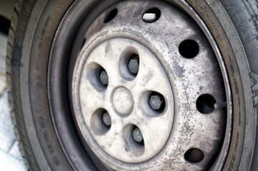 Close up of the old and damaged steel rim of a van and its tire
