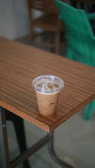 Closeup of Iced Caramel Macchiato at the coffee shop, Caramel Macchiato is a classic macchiato beverage. It consists of vanilla syrup, espresso, steamed milk, foam, and caramel drizzle