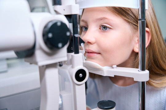 Pediatric patient undergoing eye examination on modern medical equipment