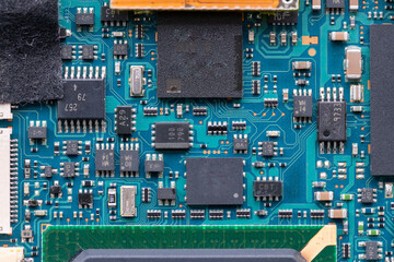 The inside of a electronic device showing the semiconductor circuit board, chip and various parts.