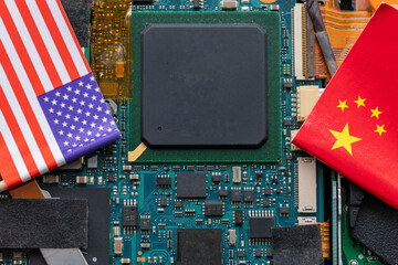 A technology conflict, competition concept with the American and Chinese flags on top of a...
