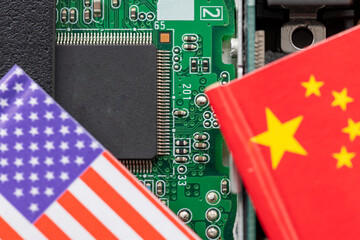 A technology conflict, competition concept with the American and Chinese flags on top of a...
