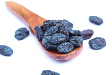 Dried raisins in a wooden spoon close-up view 