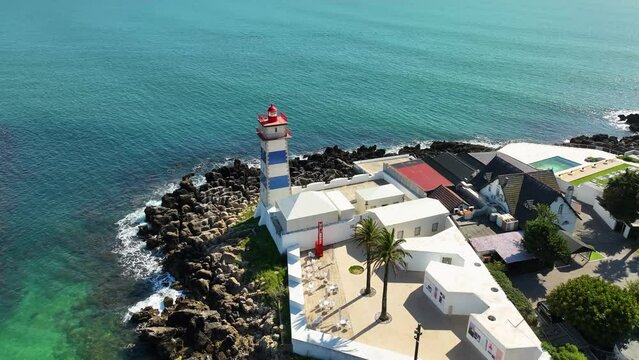 Drone fottage of the lighthouse in port of Cascais in Portugal, Spring 2023