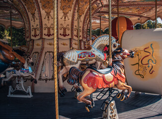 Fototapeta na wymiar Vintage fair horse carousel in amusement park concept photo