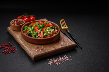 Delicious fresh salad of green beans, peas, sweet peppers and cheese