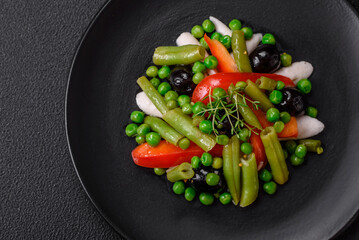Delicious fresh salad of green beans, peas, sweet peppers and cheese