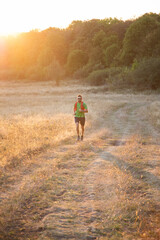 Obraz premium trail runner running at sunset