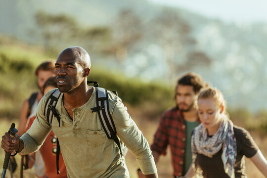 Young and diverse group of people hiking together in Africa