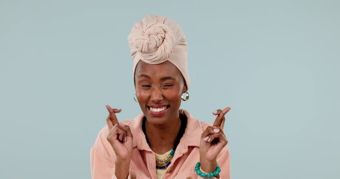 Fingers crossed, woman and hope for success in studio, waiting for luck and results on grey background. Happy african model, hands and wish for bonus, winning lottery prize and emoji sign for praying