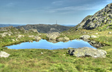 A view of reflections in lake on Mount Ulriken above Bergen, Norway in summertime