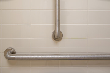Closeup of bathroom accessible grab handles, bars, on a wall next to a toilet.
 - obrazy, fototapety, plakaty
