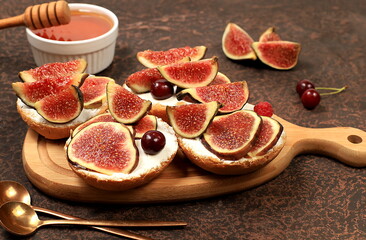 Healthy breakfast with ingredients, toast with figs and soft cream cheese ricotta and honey,...