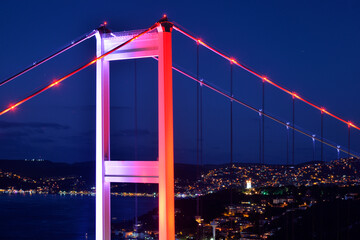 Illuminated bridge pylon top in Istanbul at evening time