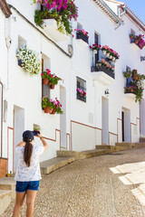 Young Woman Taking Pictures During Vacations In A Greek City