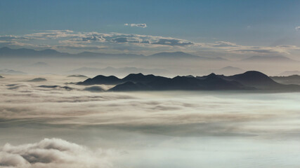 Morning vista view of Lake Elsinore basin filled with fog and low clouds.