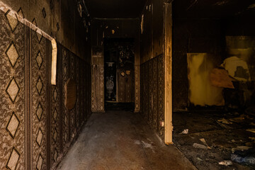 Fototapeta na wymiar Burnt apartment house interior. Consequences of fire