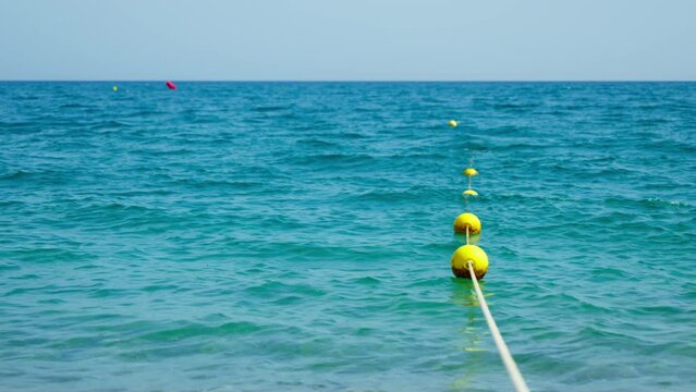 View of yellow buoys on the beach, beautiful water