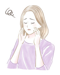 目を閉じて顔を触って肌に悩む綺麗なシニア女性　ロングヘア