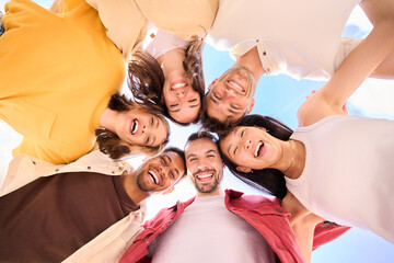 Group of young cheerful multiracial friends looking at camera hugging happy in community. Six...