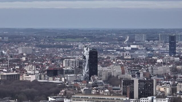 Brussels, beneath overcast hues: A city of commerce, culture, and countless rooftops.

