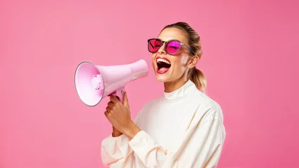 Fotobehang Trendy young woman screaming in a loudspeaker, announcing discount and offer sales, pastel pink background, black friday shopping concept, megaphone, hurry © OpticalDesign