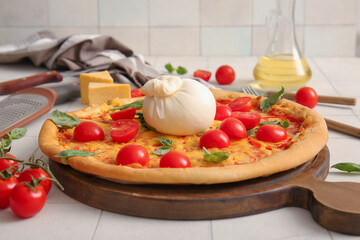 Wooden board of tasty pizza with Burrata cheese on white tile background