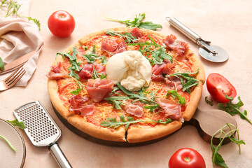 Wooden board of tasty pizza with Burrata cheese on beige background