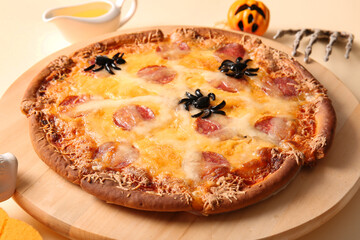 Wooden board with tasty pizza for Halloween celebration on yellow background