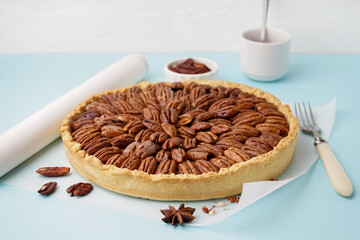 Tasty pecan pie on blue background
