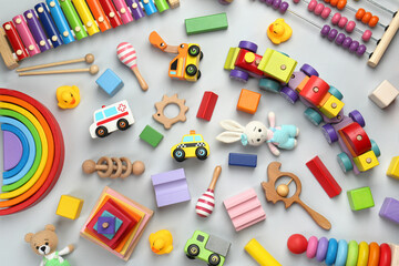 Different children's toys on light grey background, flat lay