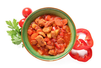 Bowl of tasty beef stew, tomatoes and bell pepper on white background