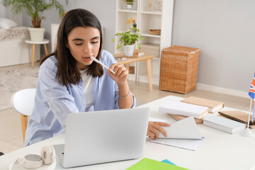 Young woman learning English language online at home