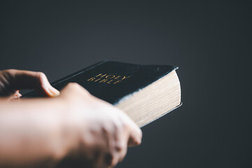 Worship christian with bible concept. Young woman person hand holding holy bible with study at...