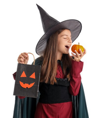 Little girl dressed for Halloween as witch with pumpkin and gift bag on white background
