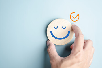 Hands holding blue happy smile face. mental health positive check up and growth mindset, mental...