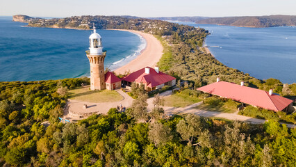 Naklejka premium Aerial drone view of Barrenjoey Head Lighthouse at Barrenjoey Headland, Palm Beach, Northern Beaches in Sydney, New South Wales, Australia on a sunny morning 