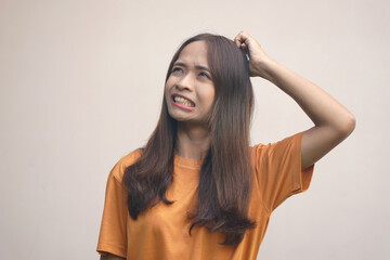 Fototapeta premium Asian woman having itchy head from dandruff..