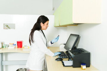 Caucasian chemist working in the medical lab using the computer