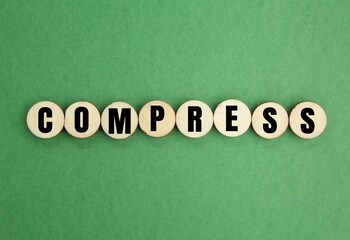 letters of the alphabet with the word compress. medical concept. flatten by pressure, squeeze or...